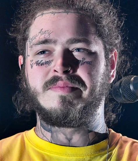 singer with tattoos on face.